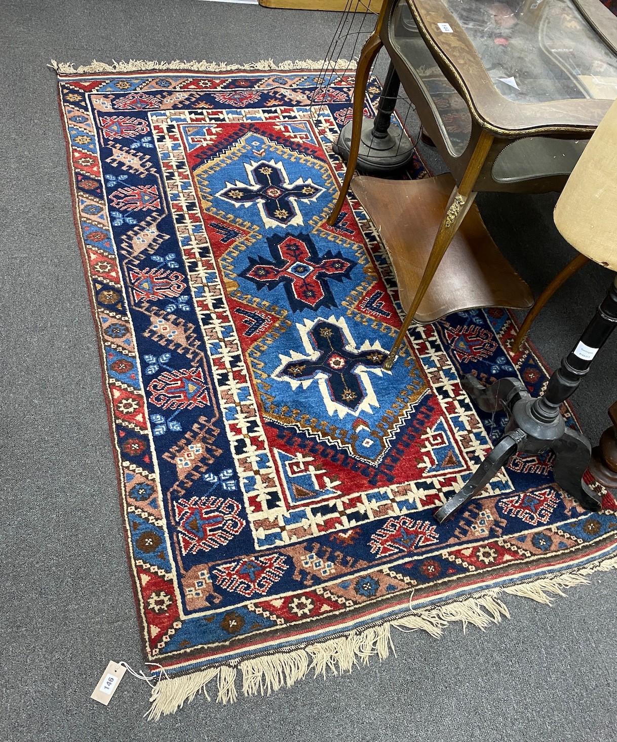 A Caucasian blue ground rug, 200cm x 118cm